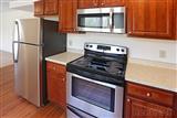 one bedroom apt. kitchen, dark cabinets, stainless appliances