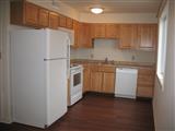 two bedroom apt. kitchen, light cabinets, white appliances