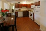 two bedroom apt. kitchen, dark cabinets, white appliances